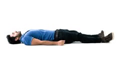 a man laying on the ground with his head down