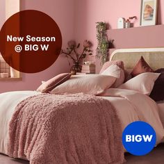 a bedroom with pink walls and bedding in the center is featured by big w