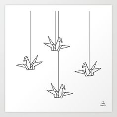 three origami birds hanging from strings