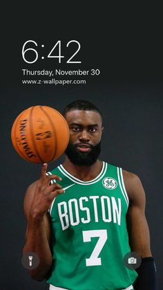 a man holding a basketball in his right hand and wearing a green jersey with the number 7 on it