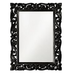 an ornate black framed mirror on a white background