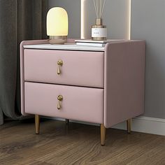 a pink night stand with two drawers and a lamp