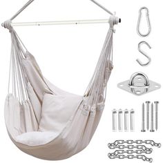 a white hammock hanging from a metal bar with hooks and chains around it