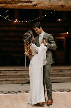 a man and woman standing next to each other on top of a wooden dance floor