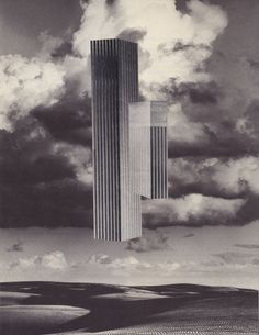 a tall building surrounded by clouds in the sky