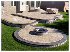 an outdoor patio with steps and fire pit