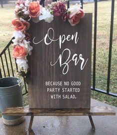 a wooden sign that says open bar because no good party started with salad