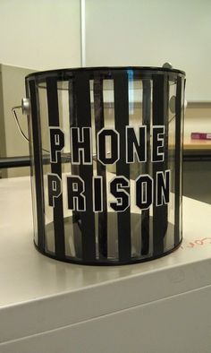 a phone prison bucket sitting on top of a table