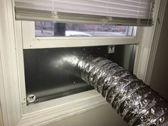 an aluminum foil wrapped window sill in front of a window with the blinds closed