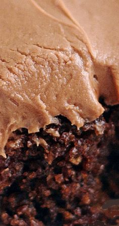 a close up view of the inside of a cake with frosting and chocolate toppings