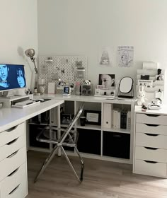 a white desk topped with a computer monitor