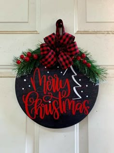 a black and red christmas sign hanging on a door