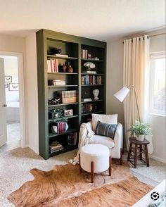 a living room filled with furniture and bookshelves