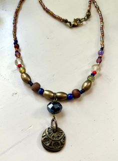 This beautiful handcrafted necklace is 17 inches and beaded with glass, wood and brass beads. It's a Pirate's Life for me! Multicolor Brass Beaded Necklaces As Gift, Brass Beaded Necklaces For Jewelry Making, Handmade Multicolor Brass Beaded Necklaces, Adjustable Brass Beaded Necklace, Handmade Multicolor Brass Beaded Necklace, Handmade Brass Beaded Necklace With Round Beads, Bronze Beaded Necklaces With Large Beads For Gift, Wooden Beads Pendant For Jewelry Making, Bronze Bohemian Beaded Necklaces With Round Beads