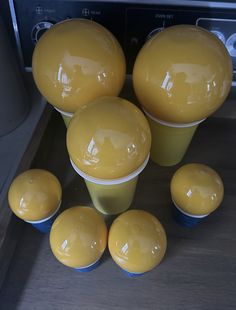 yellow dishes and cups sitting on top of a counter