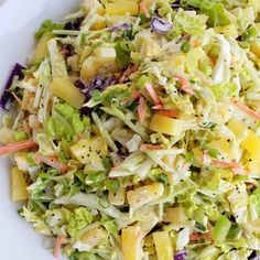 a white plate topped with a salad covered in lettuce