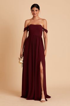 a woman in a long burgundy dress