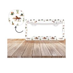 a wooden table topped with a white plate covered in horse images and cactus designs on it