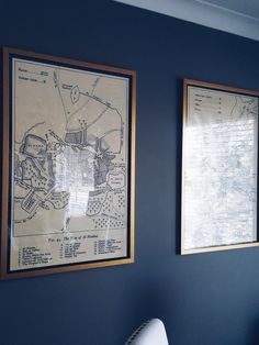 two framed maps are hanging on the wall