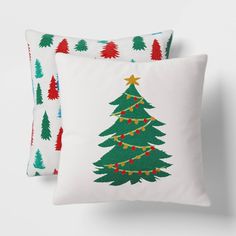 two pillows with christmas trees on them, one is green and the other is red