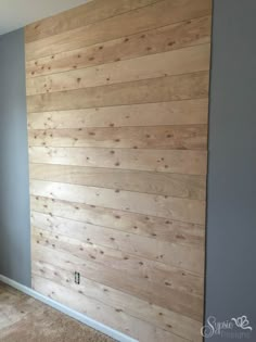 an empty room with wood paneling on the wall