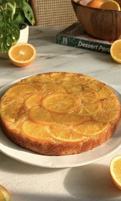 a cake on a plate with orange slices around it