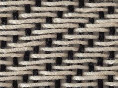 woven fabric with black and white stripes is shown in this close up photo, it appears to be woven