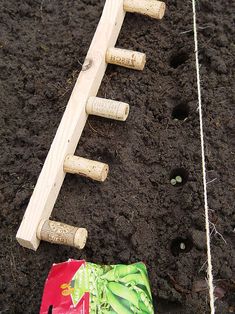 a bunch of wine corks sitting on the ground next to a bag and some string