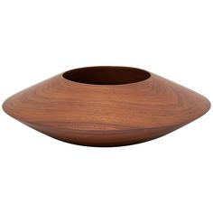 a wooden bowl sitting on top of a white surface