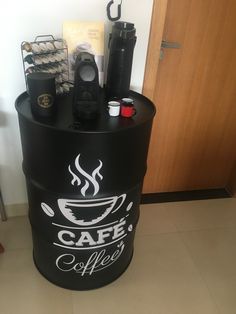 a black barrel with coffee on it sitting in front of a door