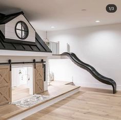 a house with a slide in front of it and a staircase leading up to the second floor