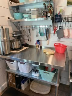 a stainless steel kitchen island with pots and pans on it