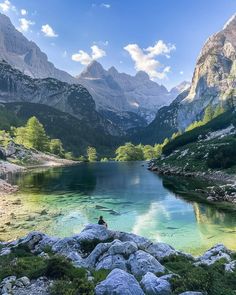 a lake surrounded by mountains and rocks