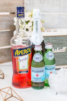 three bottles of alcohol sitting on top of a table next to an amperal