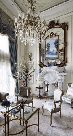 a living room filled with furniture and a chandelier