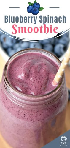 a blueberry spinach smoothie in a mason jar with a straw sticking out of it