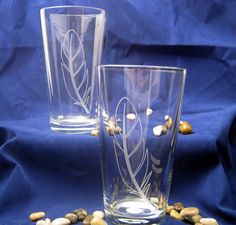 two glasses sitting next to each other on top of a blue cloth covered tablecloth