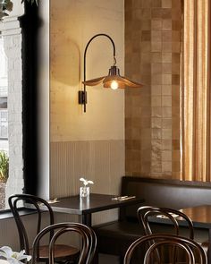 a restaurant with tables and chairs in front of a window that looks out onto the street