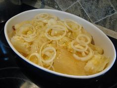 a white bowl filled with food on top of a stove