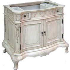 an antique white cabinet with two sinks