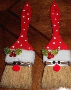 two red and white christmas decorations on top of brooms with polka dot trimming