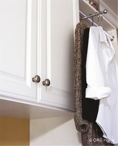 an open closet door with clothes hanging from it