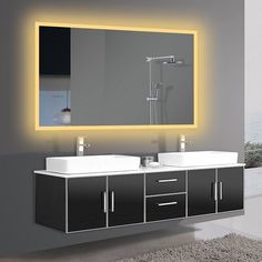 a bathroom with two sinks and a large mirror on the wall above it is illuminated by yellow lights