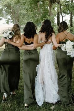 the bridesmaids are wearing green dresses with white flowers in their hair and bouquets