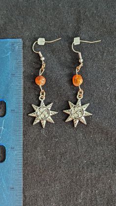 The charm on the earrings are sun shaped with candy can designs on them.  Carnelian gemstones on each earrings Hipiee Earrings, Indie Jewelry Earrings, Hippie Dangle Metal Jewelry, Sun And Moon Design Dangle Earrings For Gift, Carnelian Dangle Jewelry For Pierced Ears, Sun Design Drop Earrings For Gifts, Dangle Earrings With Sun And Moon Design For Gift, Handmade Hippie Dangle Earrings, Sun And Moon Design Dangle Earrings Gift