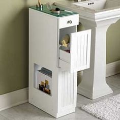 a white sink sitting next to a bathroom vanity