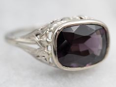 This stunning ring is the perfect blend of classic and modern style. Crafted from solid white gold, the solitaire ring features an elegant east-west spinel held in a bezel setting. Timeless and sophisticated, this exquisite ring is a stunning addition to any jewelry collection.Metal: 18K White GoldGem: Spinel ~3.00 CaratsGem Measurements: 10.8 x 7.9 mm, Cushion CutRing Size: 6.25Marks: "18K" Stamped on the inside band Classic Sapphire Ring With Bezel Setting, Modern Sapphire Ring With Bezel Setting For Formal Events, Elegant 14k White Gold Sapphire Ring With Bezel Setting, Elegant White Gold Sapphire Ring With Bezel Setting, Elegant Oval Solitaire Sapphire Ring, Elegant White Gold Amethyst Ring With Polished Finish, Elegant Black Amethyst Ring, Elegant Formal Amethyst Ring, Elegant Silver Amethyst Ring With Bezel Setting