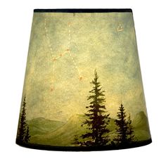 a lampshade with a painting of trees and stars in the sky on it