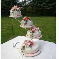 three tiered cake stands with flowers on them