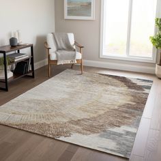 a living room area with a chair and rug on the hardwood floor next to a window